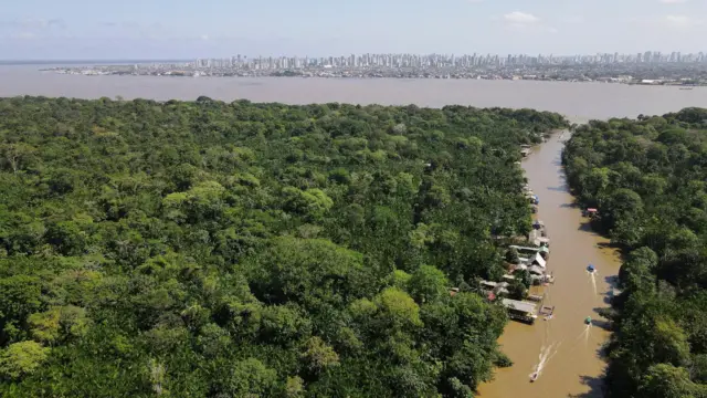 A drone image shows the Amazon rainforest and the city of Belem in the back ahead of COP 30, at Ilha do Combu, in Belem, Para state, Brazil