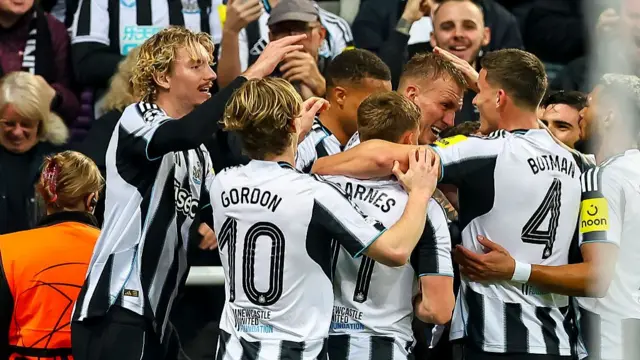 Dan Burn of Newcastle United celebrates after scoring his team's first goal with teammates