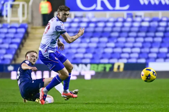 Stevenage defender Lewis Freestone (16) tackles Reading midfielder Lewis Wing (10)