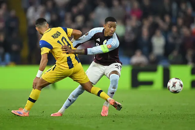 Ezri Konsa of Aston Villa is challenged by Elad Madmon of Maccabi Tel Aviv during the UEFA Europa League 2025/26 League Phase MD4 match between Aston Villa FC and Maccabi Tel-Aviv FC at Villa Park on November 06, 2025 in Birmingham, England.