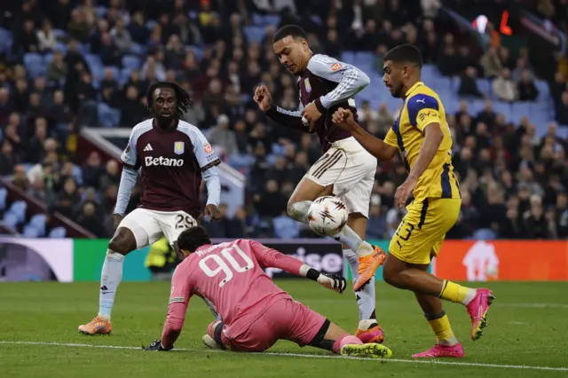 Aston Villa's Morgan Rogers in action with Maccabi Tel Aviv's Roei Mashpati and Raz Shlomo