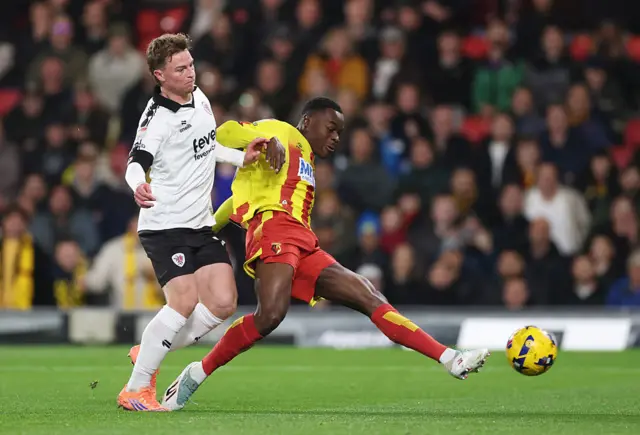 Marc Bola of Watford scores his team's first goal whilst under pressure from George Tanner of Bristol City