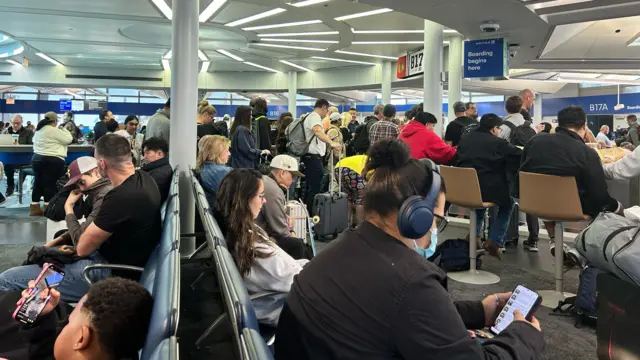 People waiting at an airport gate