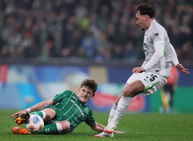Jens Stage of Werder Bremen challenges Aaron Zehnter of VfL Wolfsburg