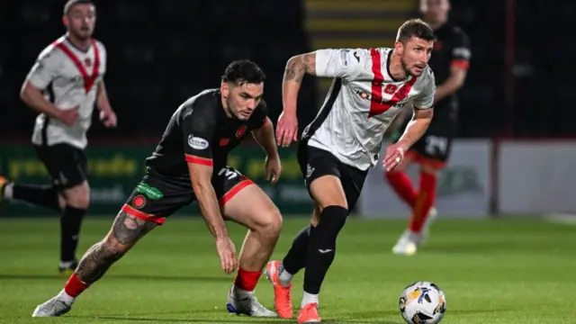 Tony Watt battles for possession