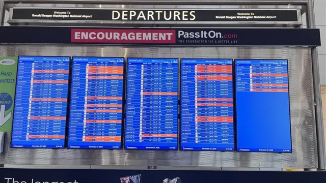 Red cancellation alerts stack up on the departures screen at Washington Reagan Airport.