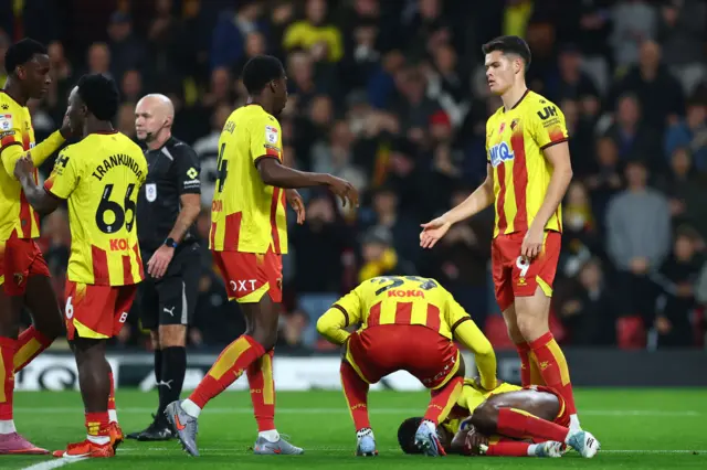 Marc Bola of Watford goes down injured after scoring a goal