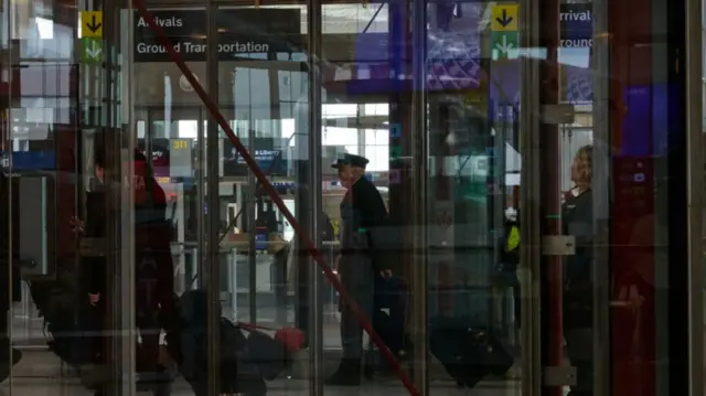 Flight crews walk in an airport