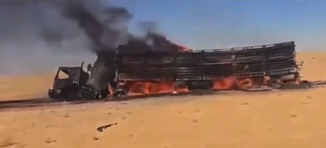 A screengrab from the second video showing one of the lorries on fire after exploding