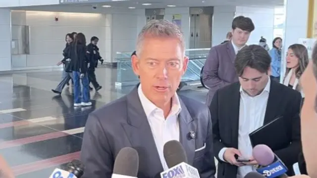 US Transportation Secretary Sean Duffy in front of several reporters' microphones