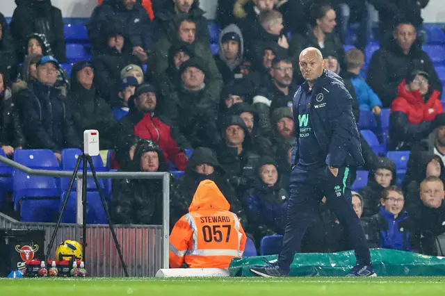 Alex Neil walks down the touchline in the rain at St Andrew's