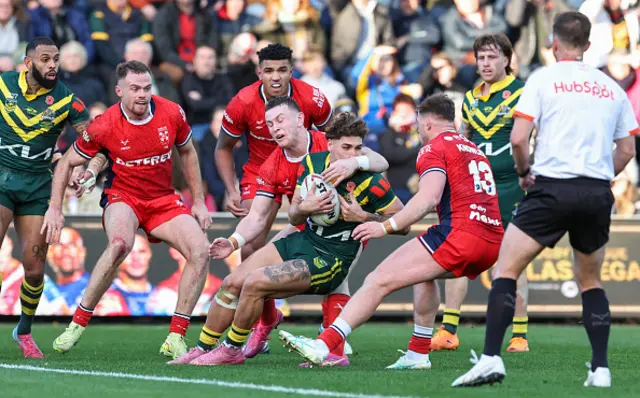 Australia's Reece Walsh is tackled by England's Harry Newman