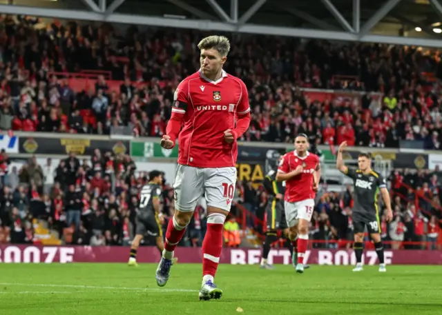 Josh Windass celebrates after scoring for Wrexham