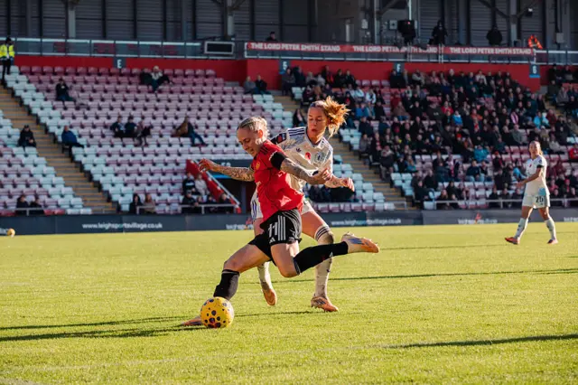 Leah Galton of Manchester United is challenged by Lynn Wilms of Aston Villa during the Barclays Women's Super League match between Manchester United and Aston Villa at Progress with Unity Stadium on November 08, 2025 in Leigh, England.