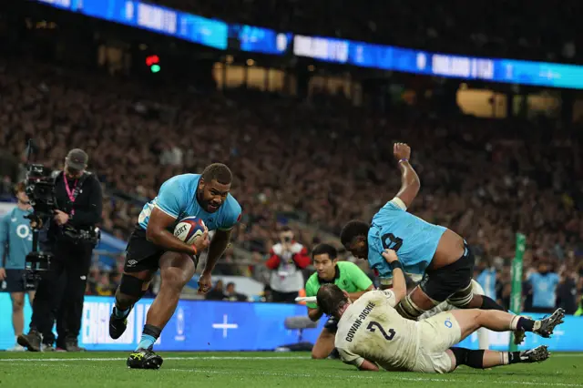 Fiji's hooker Tevita Ikanivere (L) runs in his second try during the Autumn Nations Series international rugby union match