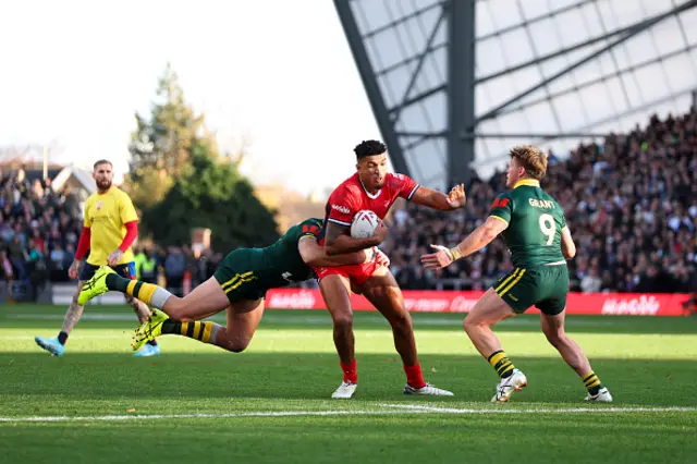 Kai Pearce-Paul of England is tackled by Patrick Carrigan