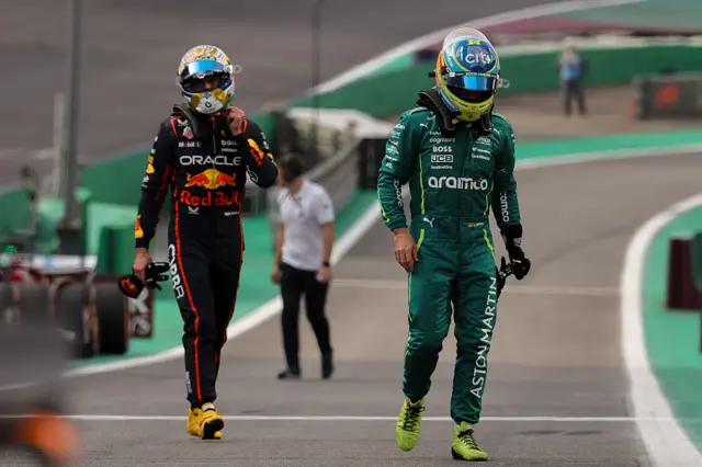 Max Verstappen and Fernando Alonso walk back to the paddock after sprint qualifying