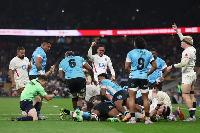 Jamie George (obstructed) of England scores his team's fourth try as Alex Mitchell and Henry Pollock celebrate during the Quilter Nations Series