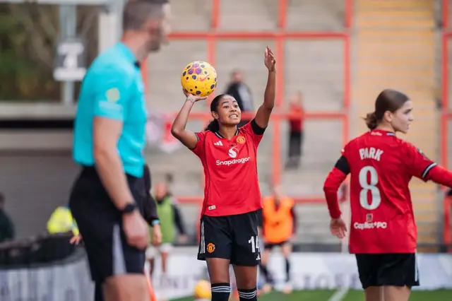 Riviere directs her teammates as she prepares to take a throw in