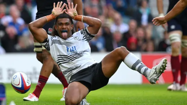 Simione Kuruvolia of Fiji celebrates scoring the team's third try