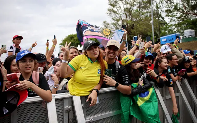 Fans pose for photographs in the fan zone