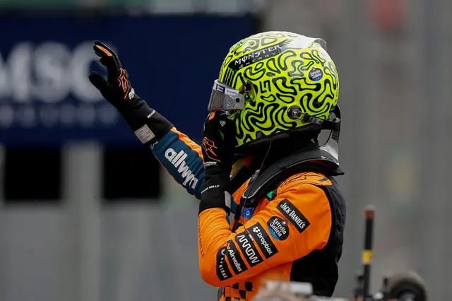 Lando Norris waves to the crowd