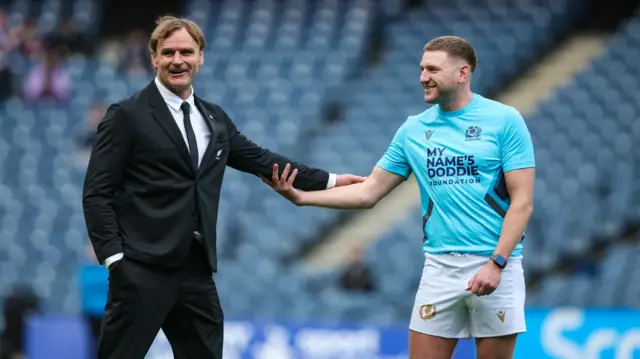 Scott Robertson shakes hands with Finn Russell