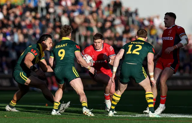 England's Morgan Knowles runs with the ball