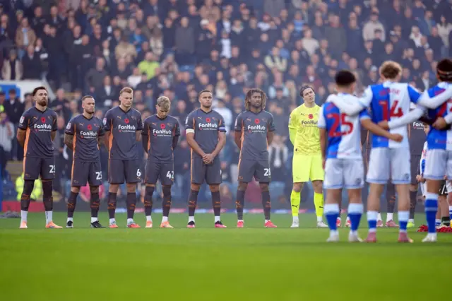 Derby County and Blackburn Rovers’ players observe a minutes silence for Remembrance Sunday