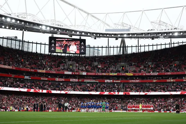 Match officials and players of Chelsea and Arsenal, stand for a minutes silence ahead of Remembrance Sunday prior to the Barclays Women's Super League match between Arsenal and Chelsea FC at the Emirates Stadium on November 08, 2025 in London, England.