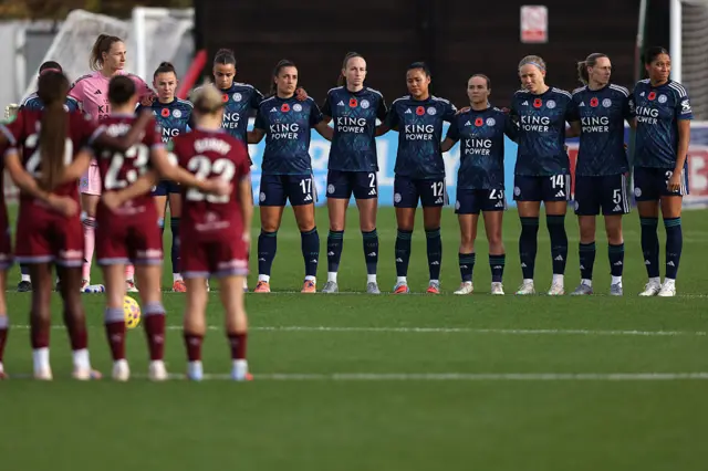 The players of Leicester City and West Ham United pause for a minutes' silence