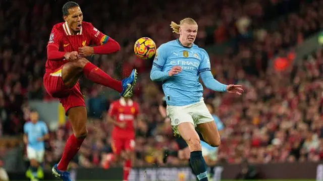 Liverpool's Virgil van Dijk is in action with Manchester City's Erling Haaland