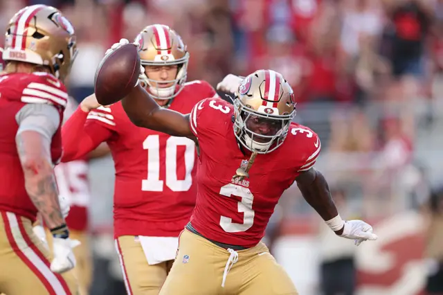 Brian Robinson Jr. celebrates after scoring a touchdown