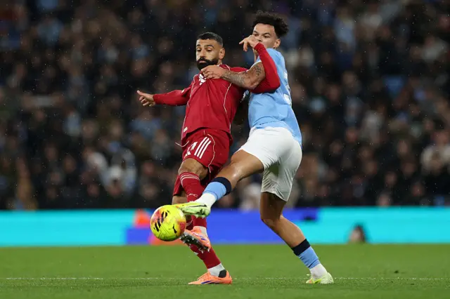 Mohamed Salah and Nico O'Reilly compete for the ball