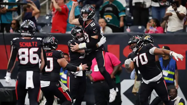 Houston Texans players celebrate after taking the lead against Jacksonville