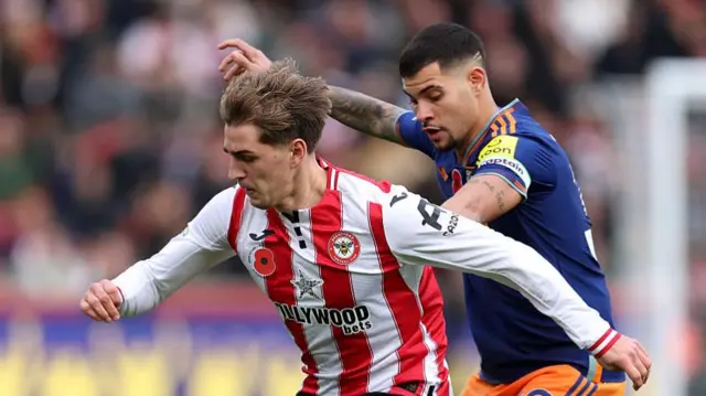 Yehor Yarmoliuk of Brentford is challenged by Bruno Guimaraes of Newcastle United during the Premier League match between Brentford and Newcastle United at Gtech Community Stadium on November 09, 2025 in Brentford, England.