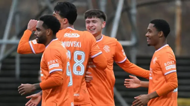 Rangers celebrate their second goal at Dens Park