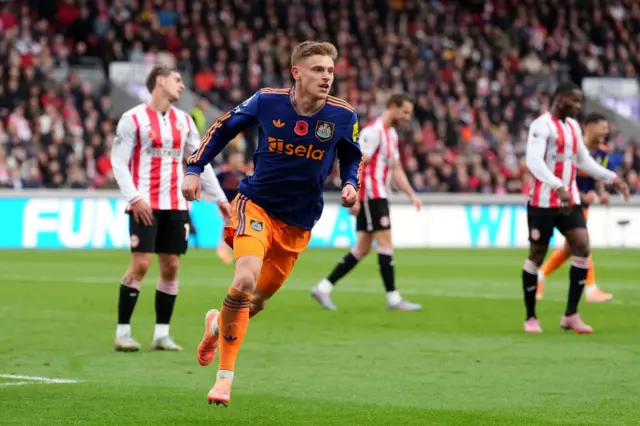 Newcastle United's Harvey Barnes celebrates scoring their side's first goal of the game during the Premier League match at the Gtech Community Stadium, London.
