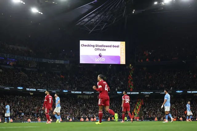 The electronic board displays the VAR decision ruling out Liverpool's Dutch defender #04 Virgil van Dijk's goal for offside during the English Premier League football match between Manchester City and Liverpool at the Etihad Stadium in Manchester, north west England, on November 9, 2025.