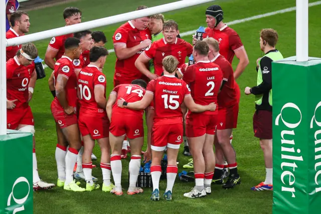 Wales players gather under the posts