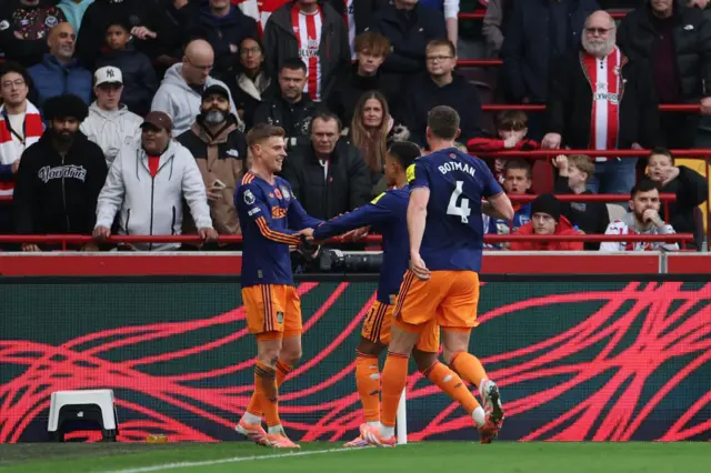 Newcastle United's Harvey Barnes celebrates scoring their first goal with Newcastle United's Jacob Ramsey and Newcastle United's Sven Botman