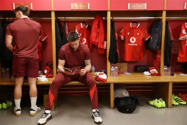Josh Adams reading in changing room