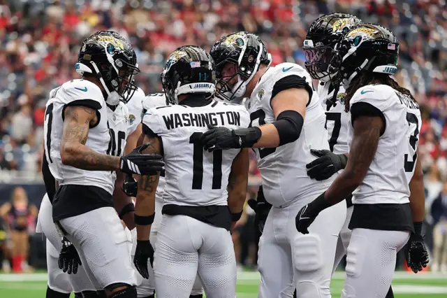 The Jaguars celebrate with Parker Washington after his touchdown