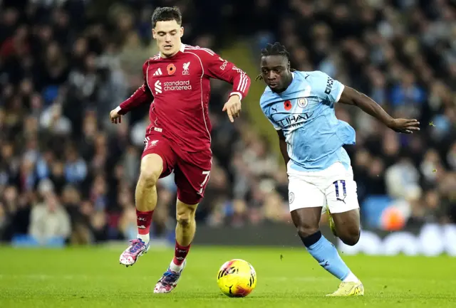 Liverpool's Florian Wirtz (left) and Manchester City's Jeremy Doku battle for the ball during the Premier League match at Etihad Stadium, Manchester.