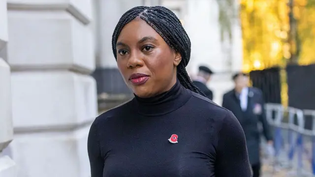 Badenoch wearing a black dress with a red poppy pin