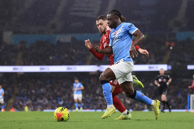 Jeremny Doku tries to dribble past Conor Bradley