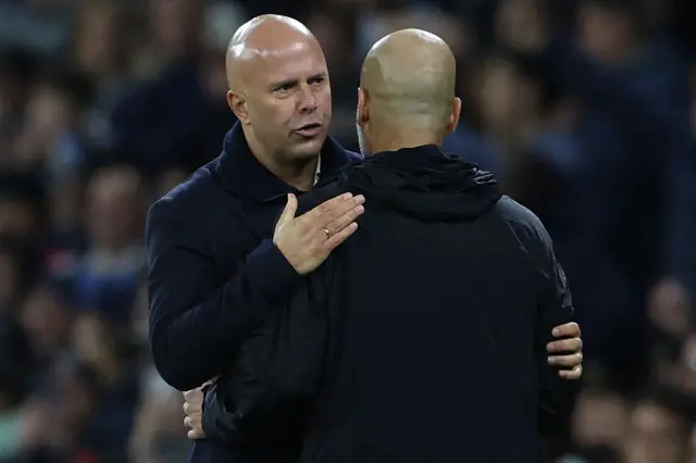 Pep Guardiola and Arne Slot embrace after the match
