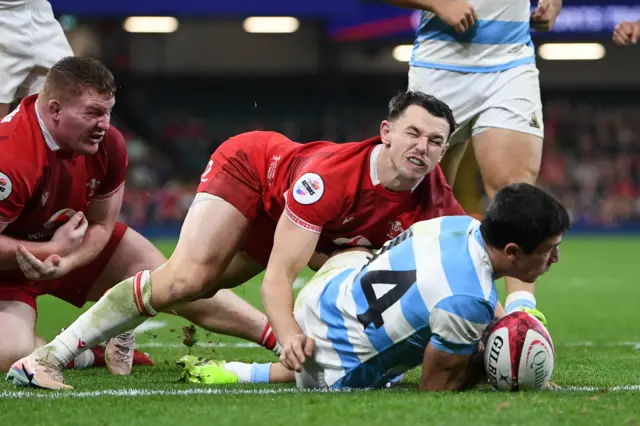 Bautista Delguy of Argentina scores a try