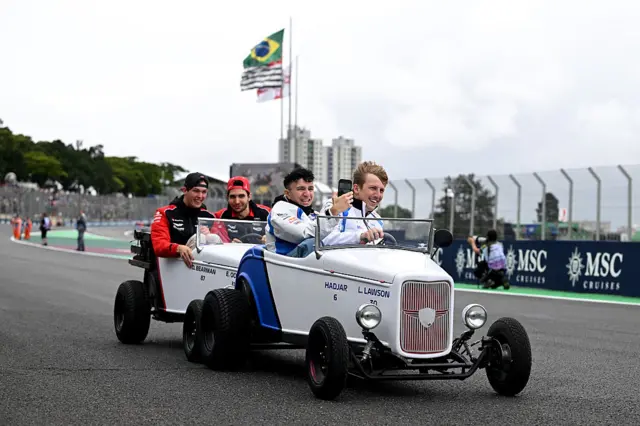 Oliver Bearman, Esteban Ocon, Isack Hadjar and Liam Lawson drive mini cars at Interlagos