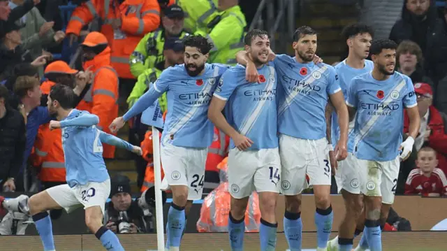 Manchester City players celebrate a goal